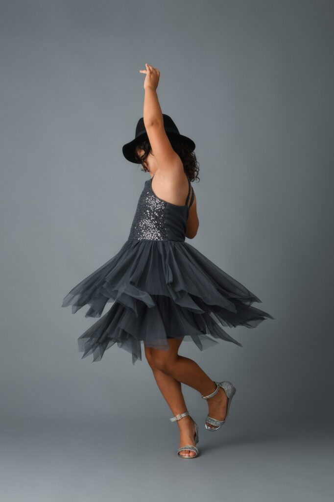 young girl dancing in her new dress