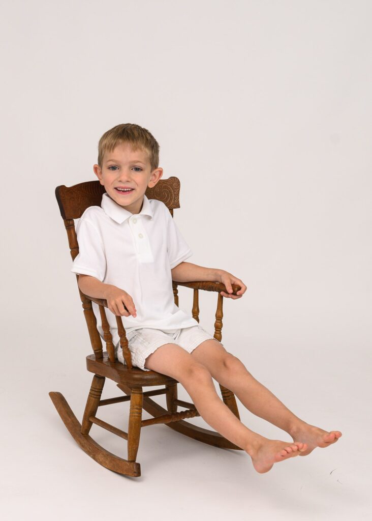 young boy in rocking chair