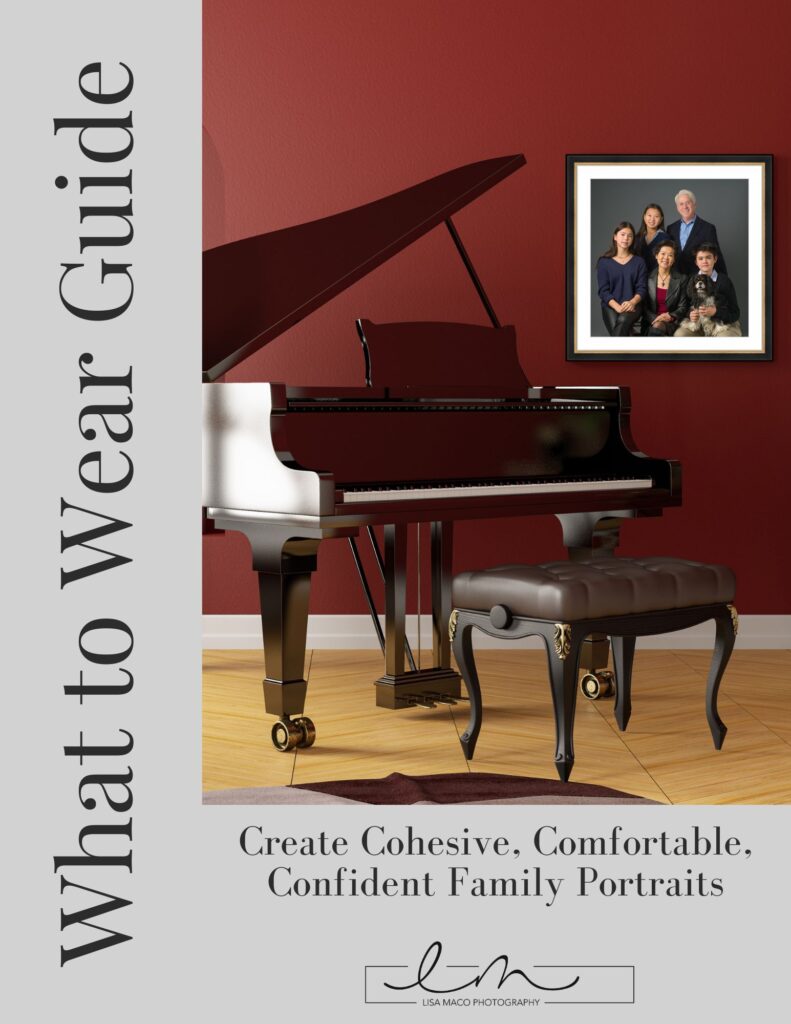 Grand piano with bench against red wall and framed family portrait, promoting cohesive family portrait guide